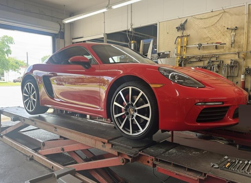 Red Porsche on the alignment rack