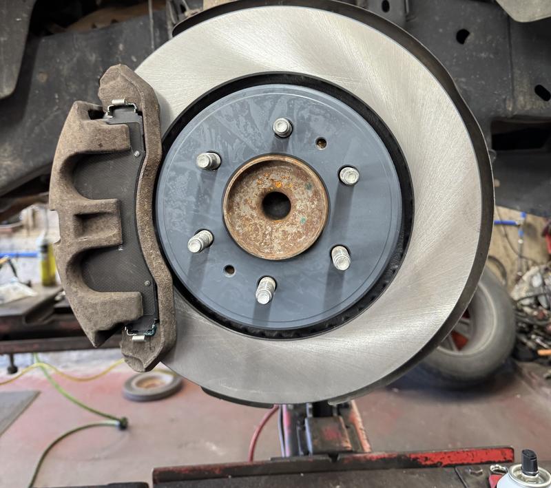 New front brake rotor installed on a truck hub